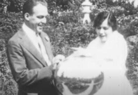 Romantic leads E.O. “Ned” Handy and Miriam Good gaze at a reflective globe in “The Portage Trail,” a 1915 melodrama filmed in Akron. The globe was at Rockynol, the estate of Goodyear executive Frank H. Adams.