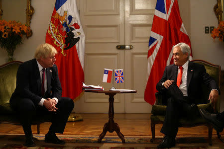 Chile's President Sebastian Pinera listens to Britain's Foreign Minister Boris Johnson as they meet in Santiago, Chile, May 23, 2018. REUTERS/Ivan Alvarado
