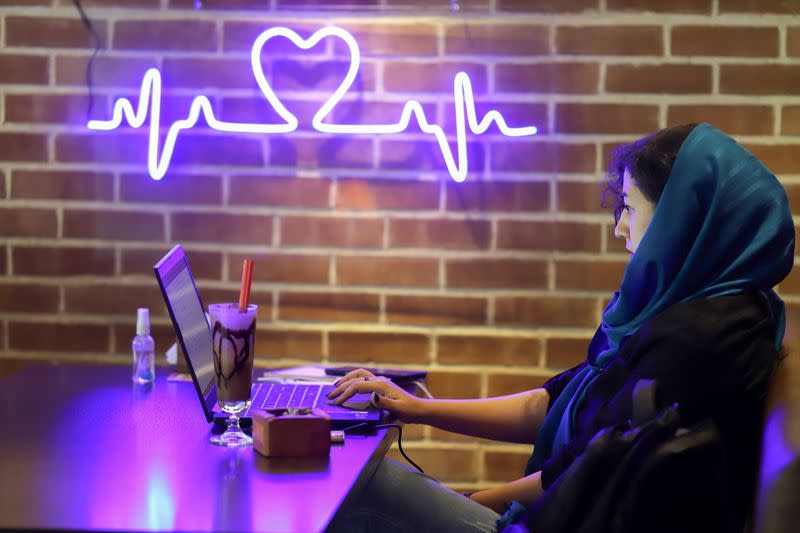 An Iranian woman sits in a cafe after the launching of the "Hamdam" dating app, in Tehran