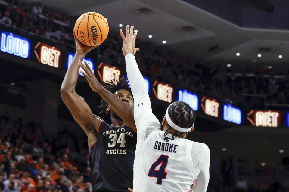 Texas A&M forward Julius Marble (34) shoots over Auburn forward Johni Broome (4) during the first half of an NCAA college basketball game Wednesday, Jan. 25, 2023, in Auburn, Ala.. (AP Photo/Butch Dill)