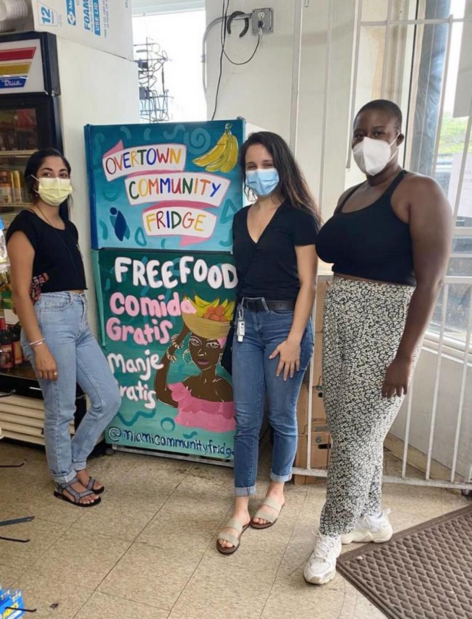 Artist Natalie Galindo, left, painted the new community fridge in Overtown.