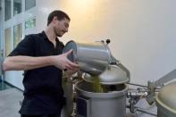 An employee fills hops in a tank at the Halve Maan brewery in Bruges, Belgium, September 15, 2016. REUTERS/Eric Vidal