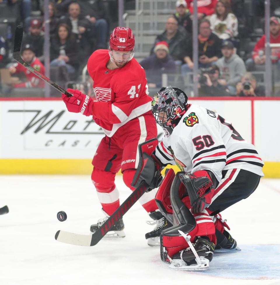 Detroit Red Wings left wing Darren Helm (43) takes a shot against Chicago Blackhawks goaltender Corey Crawford (50) during first period action Friday, March 6, 2020 at Little Caesars Arena in Detroit, Mich.