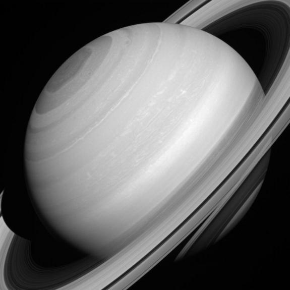 An image captured by the Cassini spacecraft shows the streaks of material that make up the planet's rings.