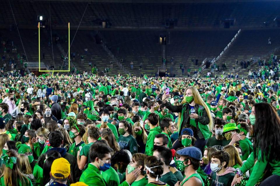 Fans storm the field after Notre Dame defeated the Clemson 47-40 in two overtimes in an NCAA college football game Saturday, Nov. 7, 2020, in South Bend, Ind. (Matt Cashore/Pool Photo via AP)