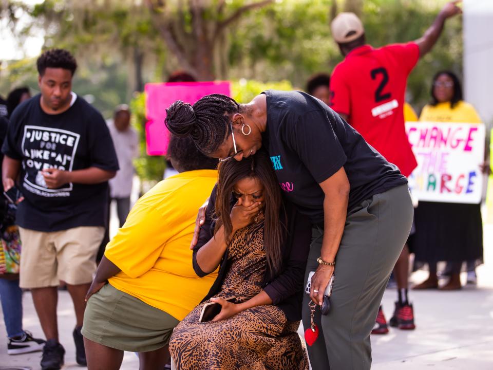 Kimberly Wilkerson of War Cry 4 Peace, right, consoles Charnelle Gibson, center, after she spoke during the protest.
