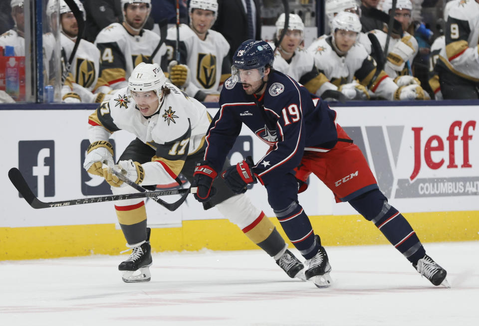 Vegas Golden Knights' Ben Hutton, left, and Columbus Blue Jackets' Liam Foudy chase a loose puck during the second period of an NHL hockey game on Monday, Nov. 28, 2022, in Columbus, Ohio. (AP Photo/Jay LaPrete)