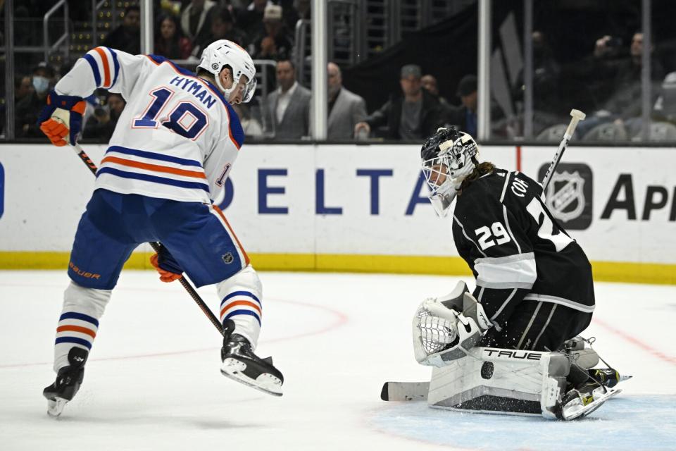 Edmonton Oilers left wing Zach Hyman, left, tries to get a shot past Kings goaltender Pheonix Copley on April 4, 2023.