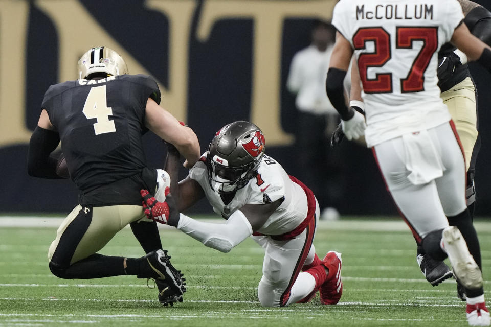 New Orleans Saints quarterback Derek Carr (4) is tackled by Tampa Bay Buccaneers linebacker Shaquil Barrett (7) in the second half of an NFL football game in New Orleans, Sunday, Oct. 1, 2023. (AP Photo/Gerald Herbert)