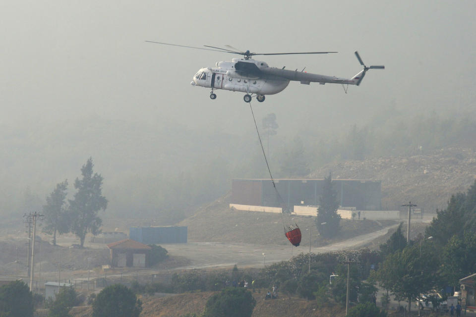A water-dropping aircraft flies over the Bordubet region, near Marmaris, western Turkey, Thursday, June 23, 2022. Water-dropping aircraft from Azerbaijan and Qatar on Friday joined the fight against a wind-stoked wildfire that burned for a fourth day near a popular resort in southwestern Turkey. Turkey's forestry minister meanwhile, said the fire may be close to being contained but said the wind still posed a risk. (AP Photo)