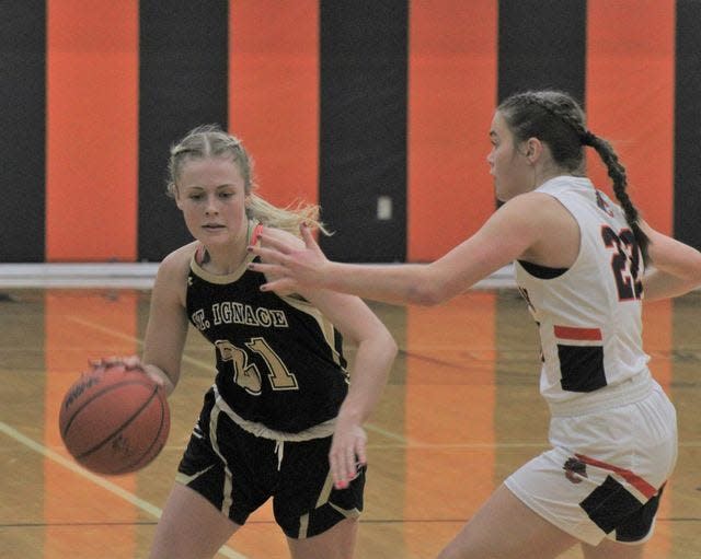 St. Ignace guard Jillian Frasier (21) and the Saints have plenty of momentum after rolling to a district final victory at Mackinaw City last week.