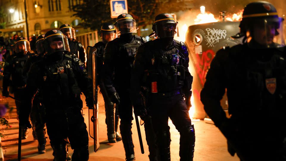 Police officers walk near a protest in Paris on June 30, 2023.  - Juan Medina/Reuters