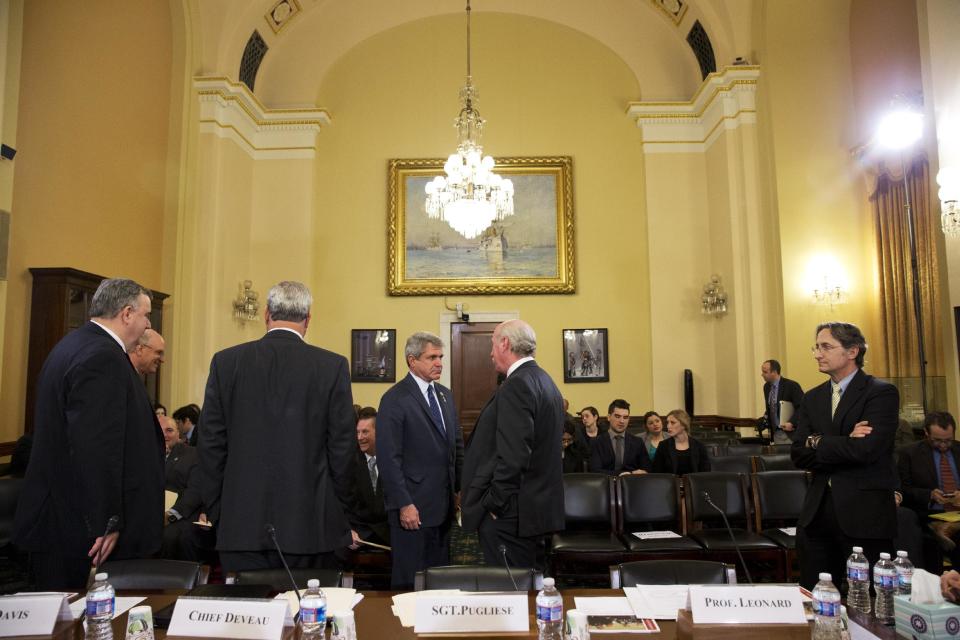 House Homeland Security Committee Chairman Rep. Michael McCaul, R-Texas, center left, greets Watertown, Mass. Police Sgt. Jeffrey Pugliese on Capitol Hill in Washington, Wednesday, April 9, 2014, before the start of the committee's hearing about the Boston Marathon Bombings leading up to the year anniversary of the attack. (AP Photo/Jacquelyn Martin)