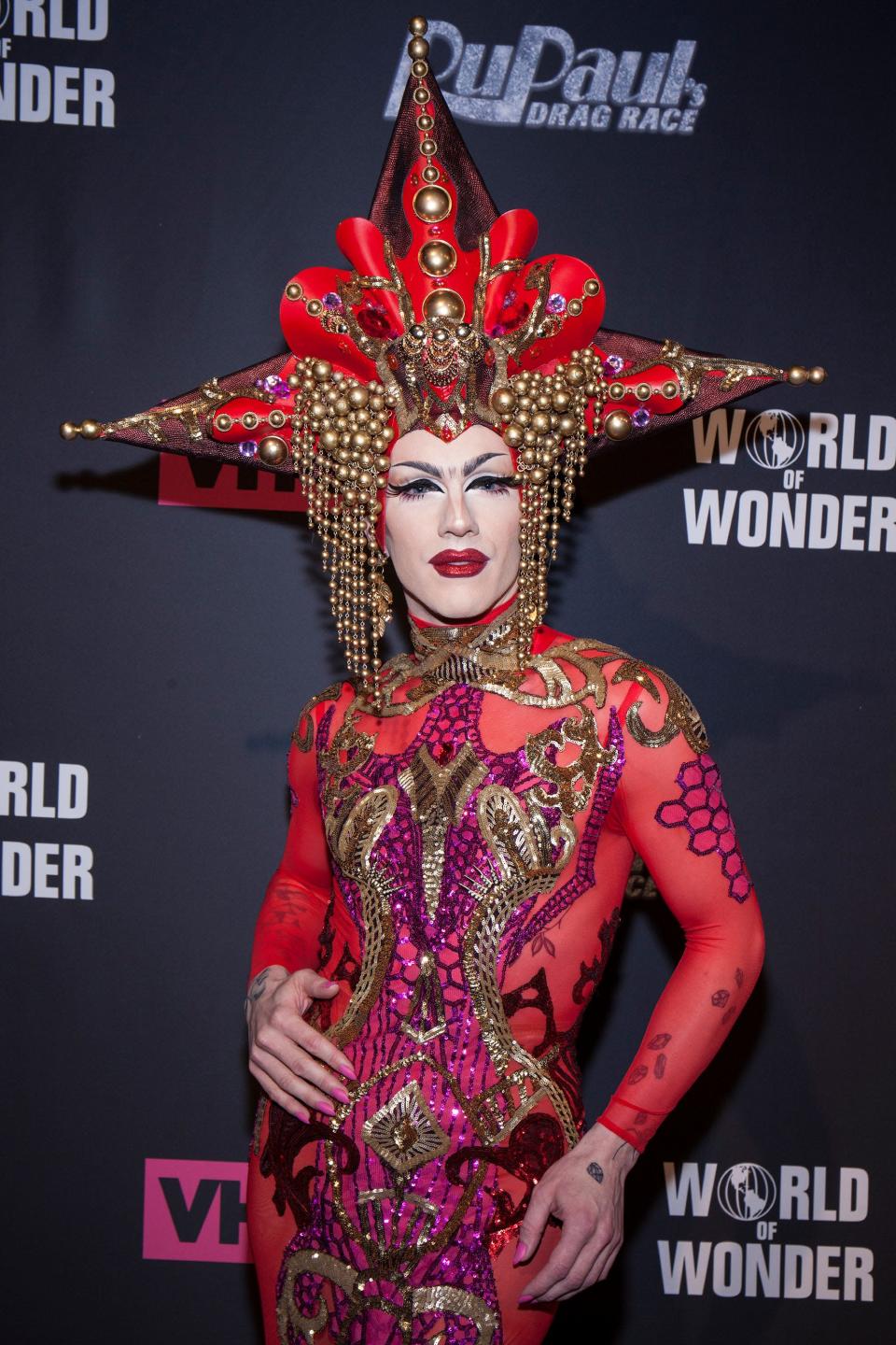 Sasha Velour in red gown and head piece