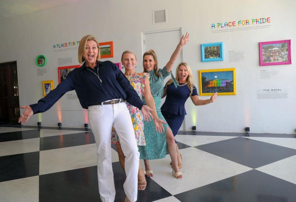 Compass Community Center Executive Director Julie Seaver, from left, Compass Chief Development Officer Julia Murphy, Royal Poinciana Plaza Marketing Director Dana Filetti, and Historical Society of Palm Beach County Director of Development Taylor Materio stand in front of the "A Place for Pride” exhibit June 23 at the Royal Poinciana Plaza.