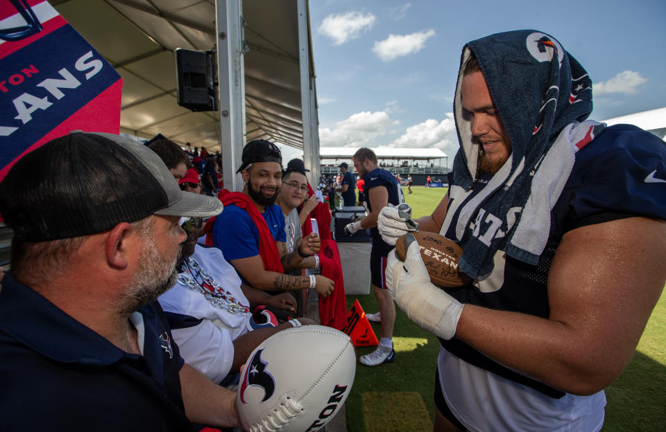 Jul 30, 2023; Houston, TX, USA; Houston Texans offensive tackle Austin Deculus (76) signs autographs for fans after training camp practice at the Houston Methodist Training Center. Mandatory Credit: Thomas Shea-USA TODAY Sports