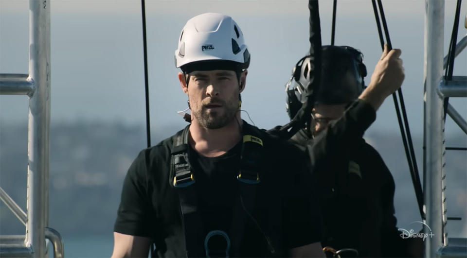 Chris Hemsworth with a hard hat on and a harness