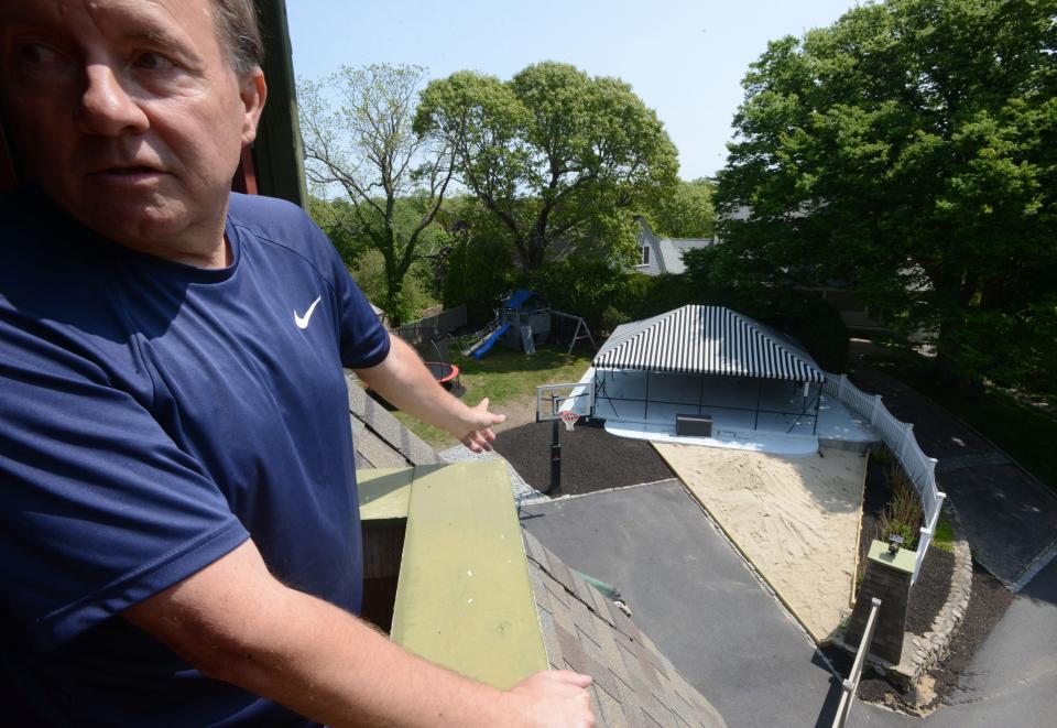 Tommy's Place founder Tim O'Connell looks out a small balcony off a third floor bedroom at the new Tommy's Place Centerville. Families with children who have cancer can apply through medical facilities for a free one-week vacation at the two Tommy's Place sites on Cape Cod.