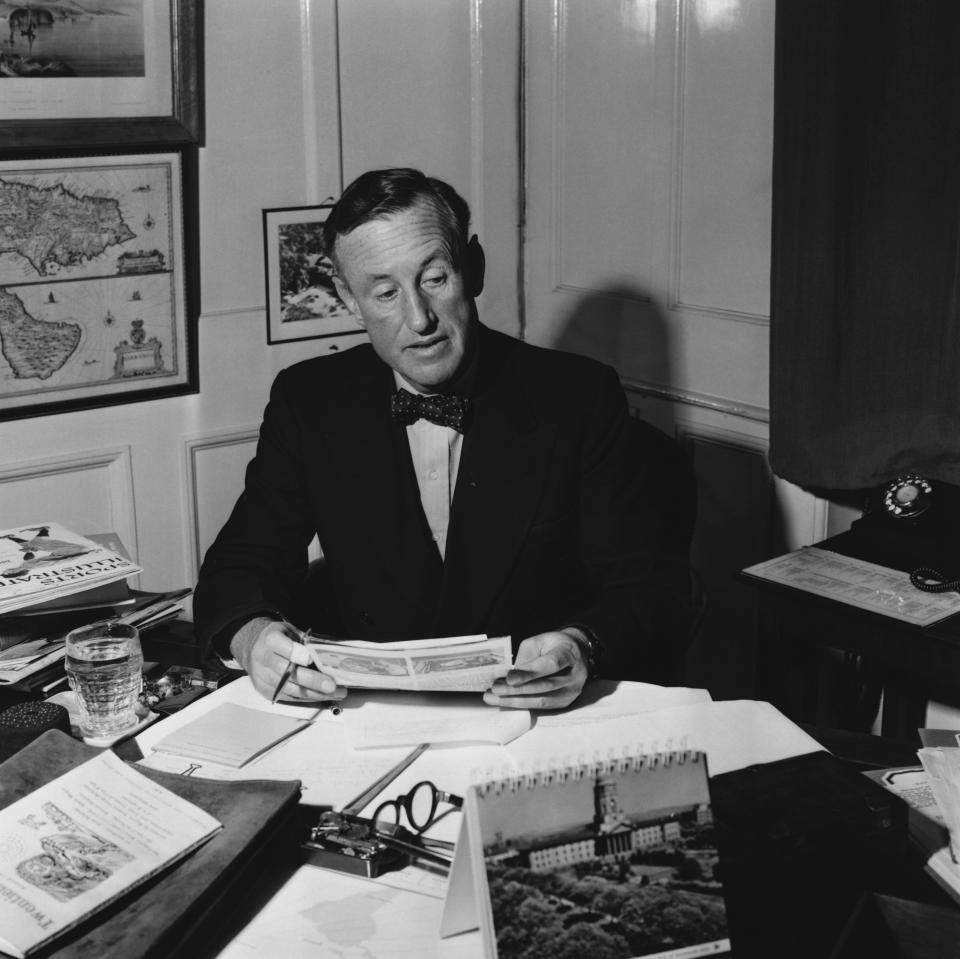 Ian Fleming (1908-1974) the English novelist in his study (1958). He worked as naval intelligence officer during the Second World War, an experience that provided him with the material for 12 novels and 7 short stories featuring his famous hero James Bond. (Photo by © Hulton-Deutsch Collection/CORBIS/Corbis via Getty Images)