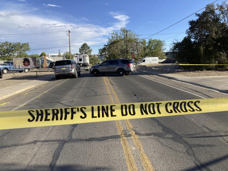 Law enforcement officers cordon off roads following a deadly shooting Monday, May 15, 2023, in Farmington, N.M. Authorities said an 18-year-old opened fire in the northwestern New Mexico community killing multiple people and injuring others before law enforcement fatally shot the suspect. (AP Photo/Susan Montoya Bryan)