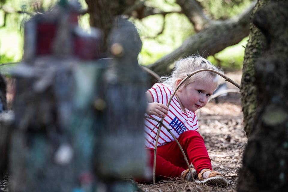 Two-year-old Emma got down on the ground for a closer look at the fairy houses at the Fairy Forest at Yew Dell Botanical Gardens. May 11, 2023