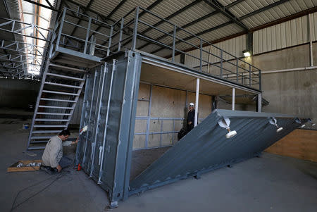 Workers transform an old steel shipping container which may later be used as living spaces or shops or restaurants in Cairo, Egypt April 19, 2017. Picture taken April 19, 2017. REUTERS/Mohamed Abd El Ghany