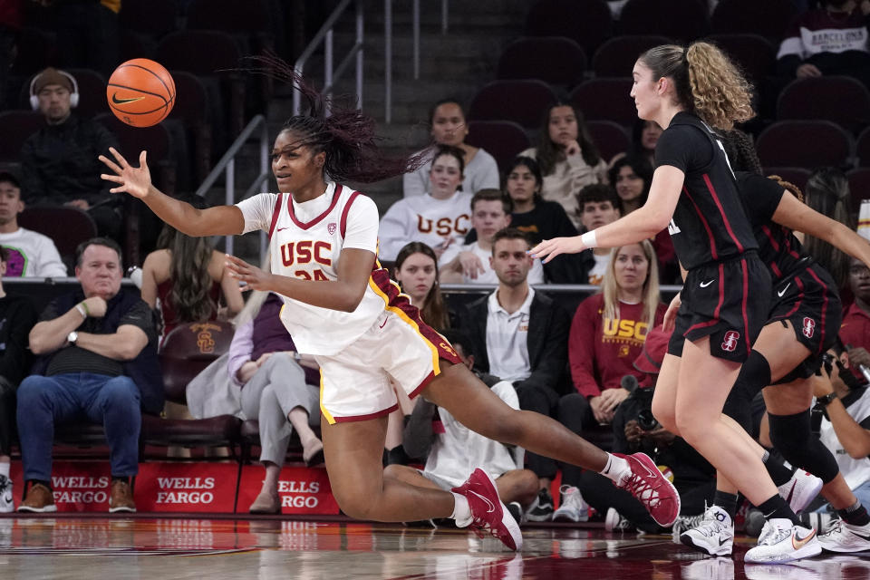 Southern California guard Okako Adika, left, as she passes the ball while under pressure from Stanford forward Brooke Demetre during the first half of an NCAA college basketball game Sunday, Jan. 15, 2023, in Los Angeles. (AP Photo/Mark J. Terrill)