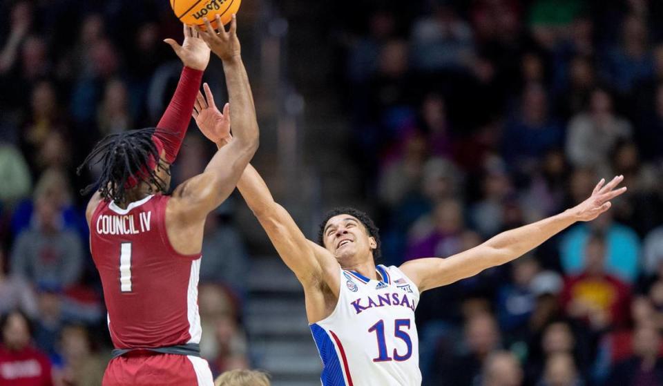 Kansas guard Kevin McCullar Jr. (15) contests a shot by Arkansas guard Ricky Council IV (1) during a second-round college basketball game in the NCAA Tournament Saturday, March 18, 2023, in Des Moines, Iowa.