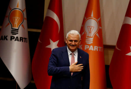 REFILE - CORRECTING DATE Turkey's likely next prime minister and incoming leader of the ruling AK Party Binali Yildirim greets party members during a meeting in Ankara, Turkey, May 19, 2016. REUTERS/Umit Bektas