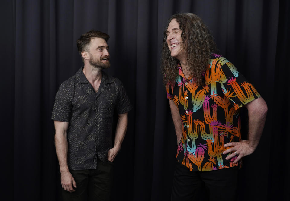 Daniel Radcliffe, left, and "Weird Al" Yankovic share a laugh as they pose for a portrait at the Bisha Hotel, during the Toronto International Film Festival, Thursday, Sept. 8, 2022, in Toronto. Radcliffe plays Yankovic in the film "Weird: The Al Yankovic Story." (AP Photo/Chris Pizzello)