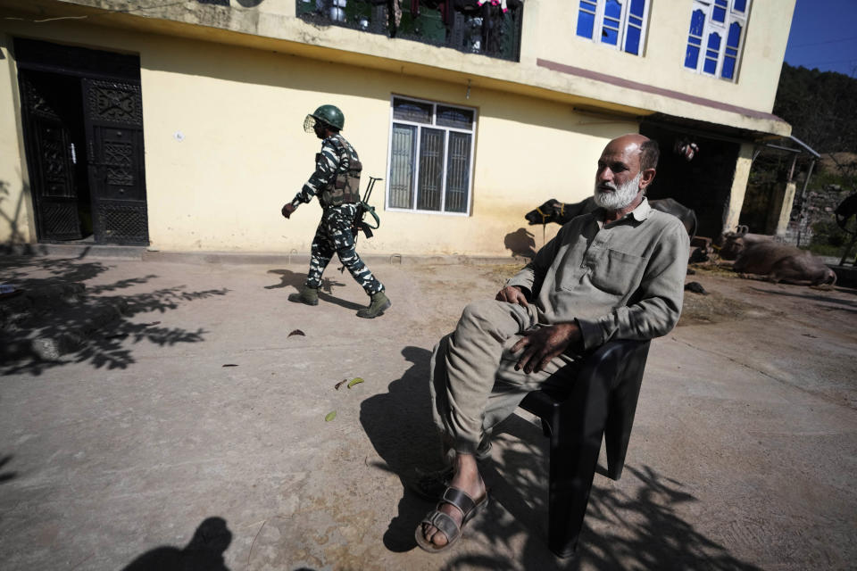 Mohammed Mushtaq, a former paramilitary soldier sits outside his house which is near the spot where the first of the two early January attacks on Hindus happened at Dhangri Village, in Rajouri, India, Feb. 7, 2023. “We have lived together for generations and have a similar social system. But fingers have been pointed at us,” he said. Days after seven Hindus were killed Indian authorities revived a government-sponsored militia and began rearming and training villagers. Mushtaq and two other Muslim neighbors, also former soldiers, asked the authorities for weapons under the policy but were refused, he said. (AP Photo/Channi Anand)