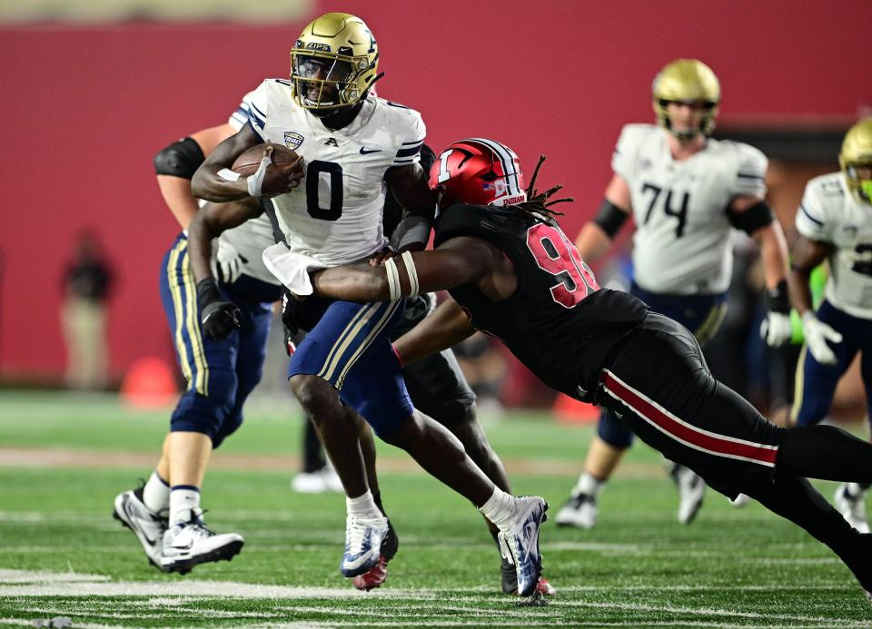 Akron Zips quarterback DJ Irons (0) is tackled by Indiana Hoosiers defensive lineman Philip Blidi (96) during the second half at Memorial Stadium on Sep 23, 2023, in Bloomington, Indiana.
