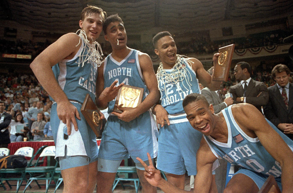 Carolina Tar Heels joke after their 96-74 Atlantic Coast Conference tournament victory over Duke on March 10, 1991. Holding plaques are, from left: Pete Chilcutt (32); Rick Fox (44), tournament MVP; King Rice (21), and Hubert Davis (40). (AP Photo/Chuck Burton)