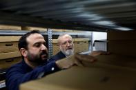 Avraham Krieger, Executive Director of Shem Olam Holocaust Memorial Centre, and Assaf Fassy, Digital Services Manager, sort through archival material at their offices in Kfar Haroeh, Israel