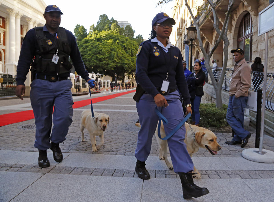 South African Police with dogs provide security at Parliament before South African President Jacob Zuma, arrives to give the State of the Nation address in the city of Cape Town, South Africa, Tuesday, June 17, 2014.  (AP Photo/Schalk van Zuydam)