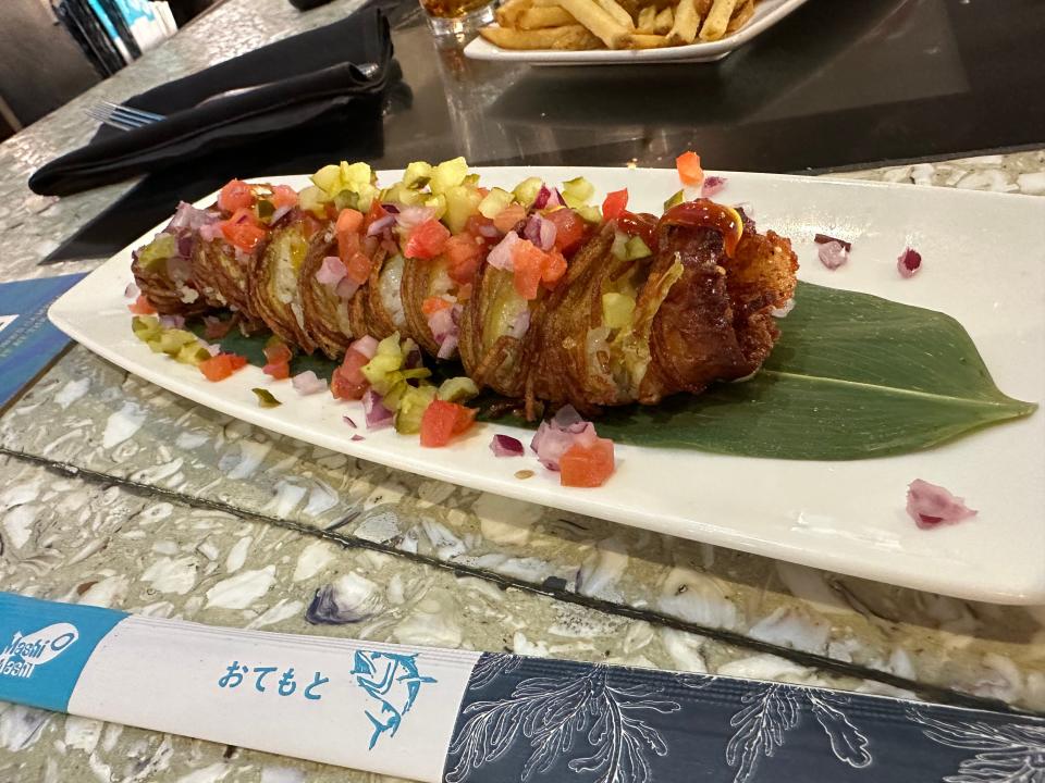 "Cheeseburgerushi" from Cowfish at Universal CityWalk on a plate next to chopsticks
