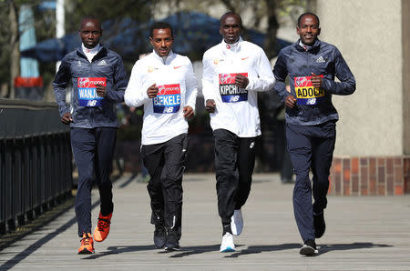 Athletics - London Marathon - Elite Men Press Conference - London, Britain - April 19, 2018 Kenya's Daniel Wanjiru and Eliud Kipchoge with Ethiopia's Kenenisa Bekele and Guye Adola pose for a photograph Action Images via Reuters/Peter Cziborra