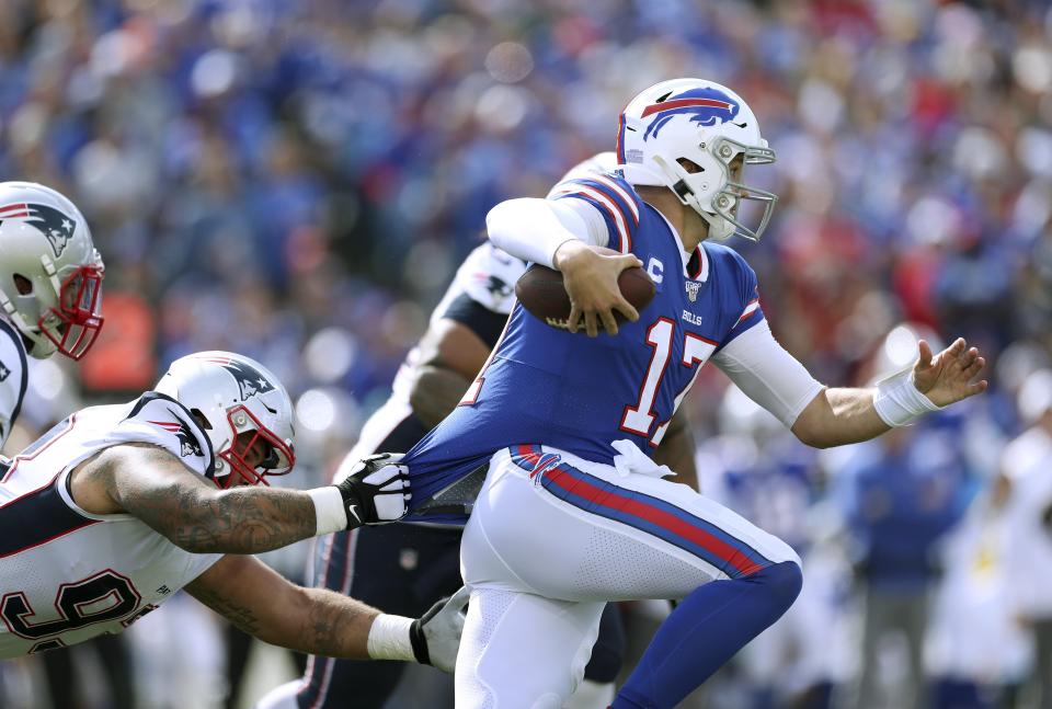 Buffalo Bills quarterback Josh Allen tries to break free from the grasp of of New England Patriots defensive tackle Lawrence Guy in the first half of an NFL football game, Sunday, Sept. 29, 2019, in Orchard Park, N.Y. (AP Photo/Ron Schwane)