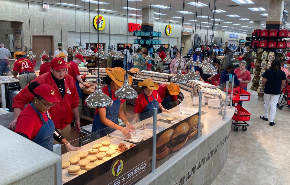 Staff members put barbecue sandwiches together at Buc-ee's in Auburn on Thursday, April 13, 2023.