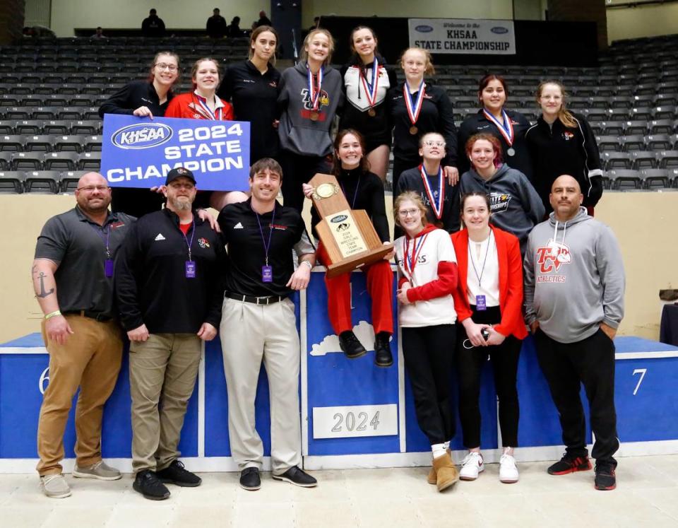 Taylor County celebrates winning the team title in the girls 2024 KHSAA Wrestling State Championships, the first sanctioned statewide tournament for the sport, at the Kentucky Horse Park’s Alltech Arena on Saturday.