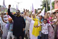 Punjabi actor Hardeep Gill and Punjabi actress Anita Devgun along with farmers and their family members shout slogans during Punjab bandh, a statewide farmers' strike against the recent passing of agriculture bills in the Parliament, on September 25, 2020 in Amritsar, India. The two bills - the Farmers (Empowerment and Protection) Agreement on Price Assurance and Farm Services Bill, 2020 and the Farming Produce Trade and Commerce (Promotion and Facilitation) Bill, 2020 - were passed by the Rajya Sabha despite uproar and strong protest by the Opposition parties in the house. (Photo by Sameer Sehgal/Hindustan Times via Getty Images)