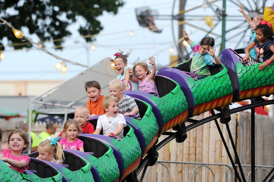 Children enjoy a kiddie roller coaster at the Holy Rosary Summer Social in 2015.