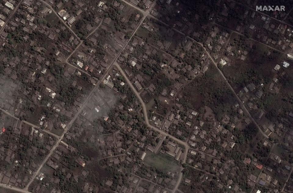 A satellite image shows ash-covered homes and buildings after the main eruption (Reuters)