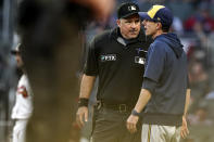 The umpire speaks to Milwaukee Brewers manager Craig Counsell during the fourth inning of Game 4 of a baseball National League Division Series against the Atlanta Braves, Tuesday, Oct. 12, 2021, in Atlanta. (AP Photo/Brynn Anderson)