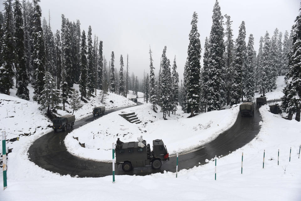 SRINAGAR, INDIA - NOVEMBER 16: Army vehicles make their way past a snow lined bend on Gulmarg road after the seasons first snowfall in the region on November 16, 2020 in Srinagar, India. (Photo by Waseem Andrabi/Hindustan Times via Getty Images)