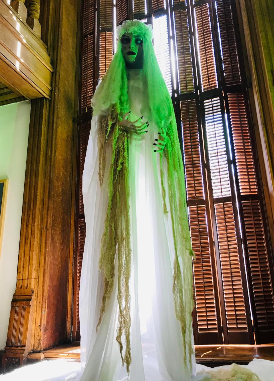 A statue Halloween decoration stands near the staircase at Evansville's Willard Library. The library is supposedly home to The Grey Lady: a now-notorious ghost who often scares  patrons and employees.