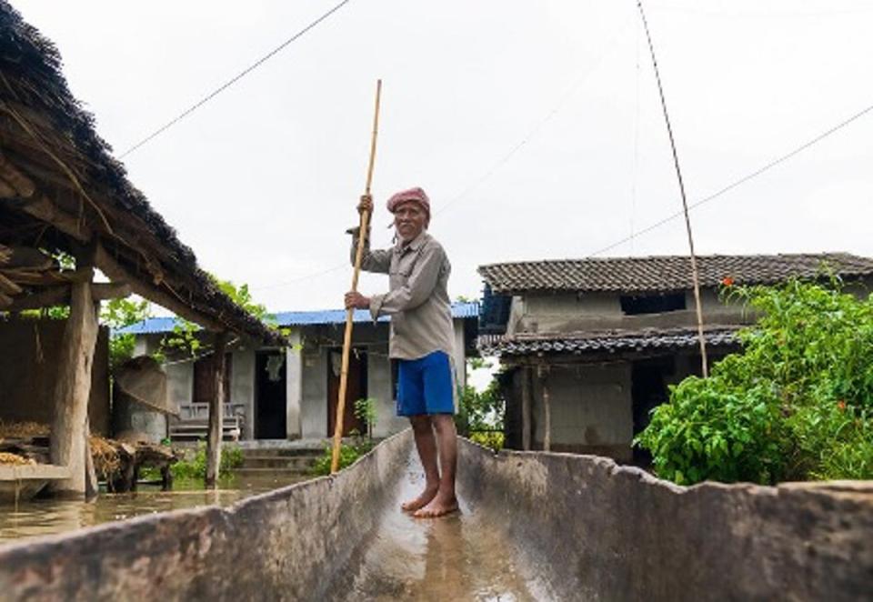 Bhagiram lost his home in Bardiya district, western Nepal, but rescued his family with his rickety wooden boat. He received anticipatory action cash support from WFP (WFP/Srawan Shrestha)