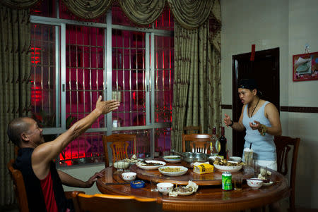 Huang Wensi and her father argue over family matters during a dinner at home in Lianjiang, Guangdong province, China, June 30, 2018. REUTERS/Yue Wu