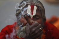 A Hindu holy man smokes marijuana during Shivaratri festival at the premises of Pashupatinath temple in Kathmandu, Nepal, Friday, Feb. 21, 2020. Hindu holy men were joined by devotees and the public Friday at a revered temple in Kathmandu where they lit up marijuana cigarettes during an annual festival despite prohibition and warning by authorities. Hindu holy men were joined by devotees and the public Friday at a revered temple in Kathmandu where they lit up marijuana cigarettes during an annual festival despite prohibition and warning by authorities. “There is a ban on smoking marijuana but at the same time it is centuries-old tradition which we have to respect,”said police officer Suman Khadka adding there was no arrests made Friday. (AP Photo/Niranjan Shrestha)