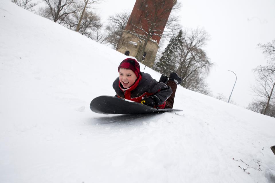 Liam Schrand, 9, sleds down at hill at Eden Park in Cincinnati in 2021.